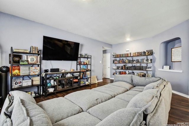 living area with wood finished floors and baseboards