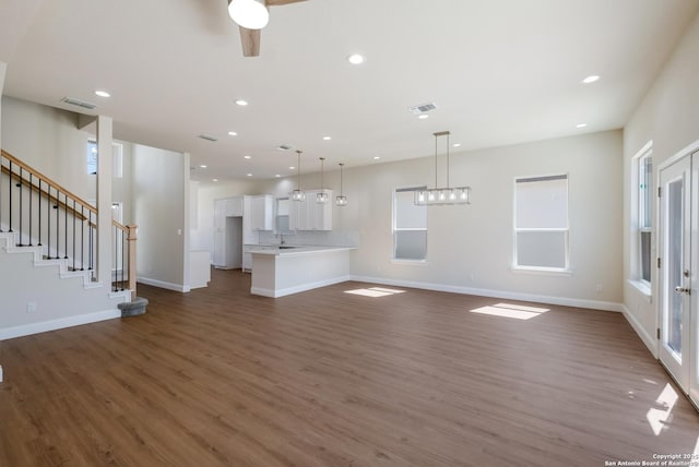 unfurnished living room featuring recessed lighting, visible vents, baseboards, and dark wood-style flooring