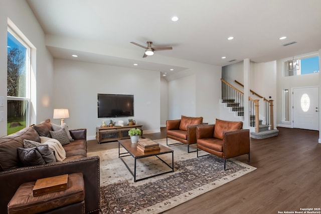 living room with a wealth of natural light, visible vents, recessed lighting, and wood finished floors