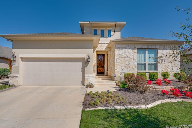 prairie-style house featuring concrete driveway, a garage, stone siding, and stucco siding