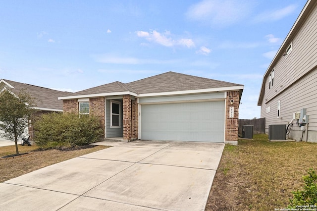 single story home featuring driveway, brick siding, central AC, and an attached garage