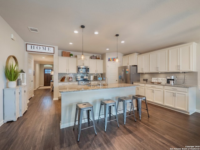 kitchen featuring white cabinetry, dark wood-type flooring, visible vents, and appliances with stainless steel finishes