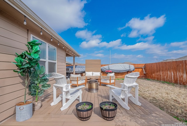 deck featuring a jacuzzi and fence private yard