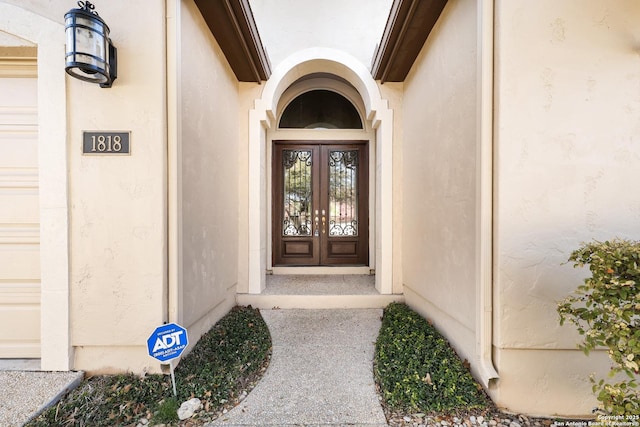 entrance to property featuring stucco siding and a garage