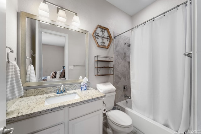 bathroom with vanity, toilet, a textured wall, and shower / bath combo with shower curtain