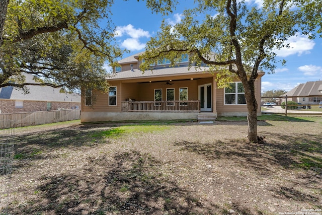 rear view of property featuring french doors, a ceiling fan, and fence