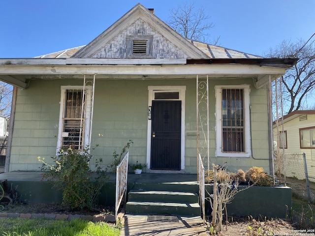 bungalow-style home with metal roof and a porch