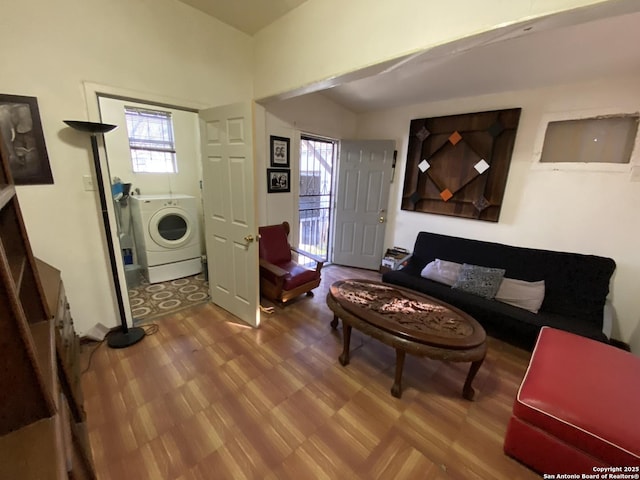 living room featuring washer / dryer and wood finished floors