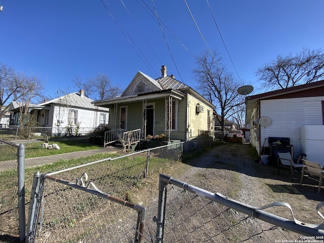 shotgun-style home with a fenced front yard