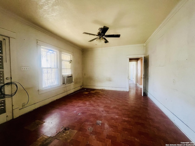 spare room with cooling unit, a ceiling fan, baseboards, and ornamental molding