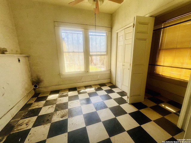 unfurnished bedroom with tile patterned floors and a ceiling fan