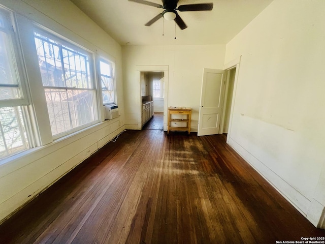 empty room with dark wood-style floors, radiator heating unit, and a ceiling fan