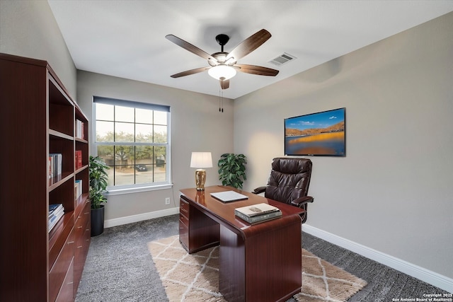 office featuring a ceiling fan, carpet flooring, baseboards, and visible vents