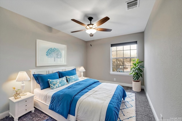 carpeted bedroom with visible vents, a ceiling fan, and baseboards