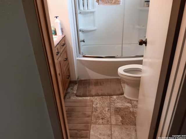 bathroom with enclosed tub / shower combo, toilet, and vanity