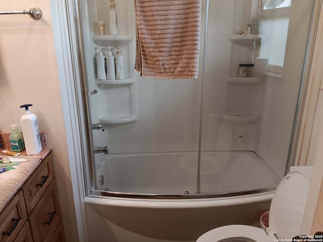 full bath with enclosed tub / shower combo and toilet