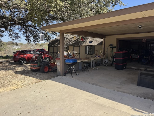 view of patio featuring a garage and an attached carport