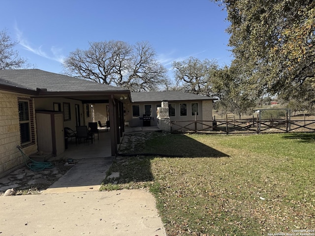 back of house with a yard, a patio area, and fence