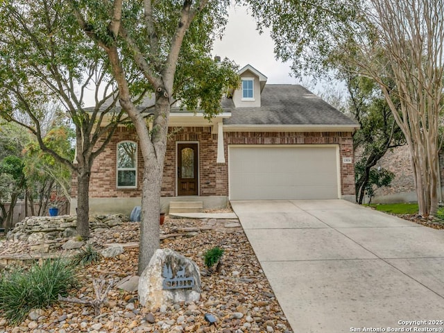 view of front of property featuring brick siding, an attached garage, and concrete driveway