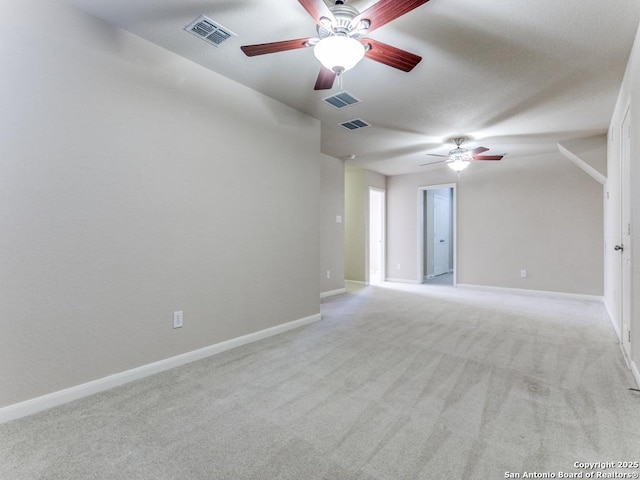 spare room featuring baseboards, visible vents, and ceiling fan