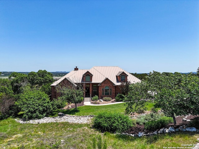 125 Enigma Ave, Spring Branch, TX 78070 - view of front of property featuring a metal roof, a chimney, a standing seam roof, and a front lawn