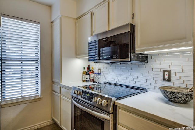 kitchen with backsplash, appliances with stainless steel finishes, and light countertops