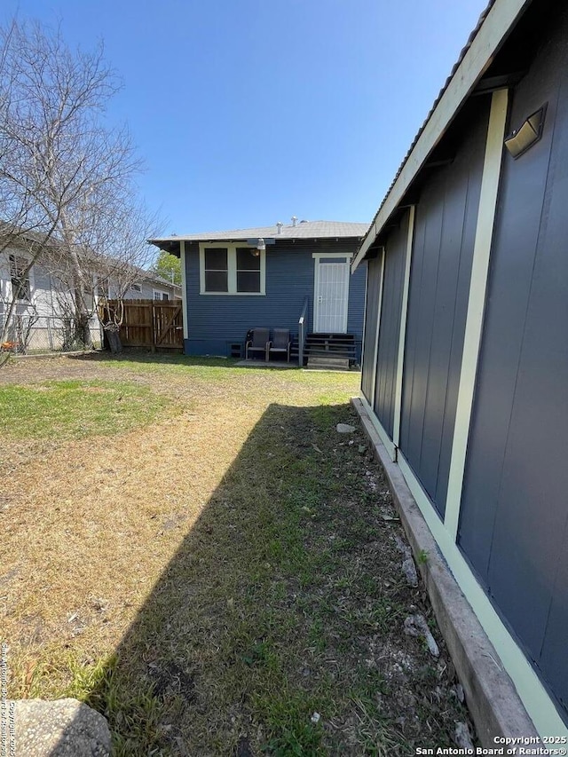 view of yard featuring fence and entry steps