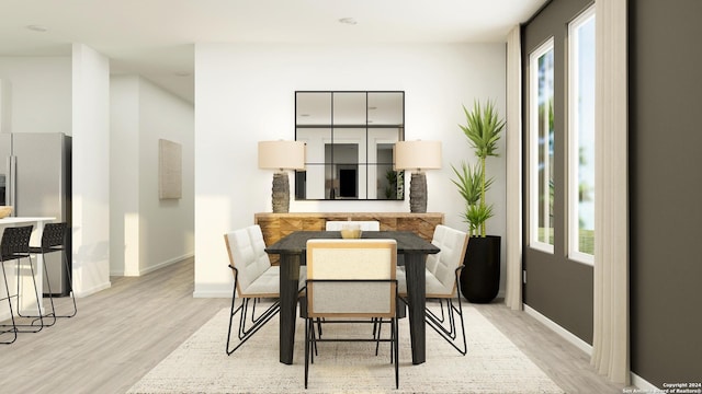 dining area featuring baseboards and light wood-style floors