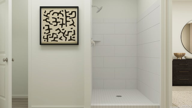 full bath featuring tiled shower