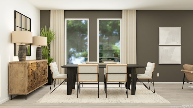 dining area with baseboards and wood finished floors
