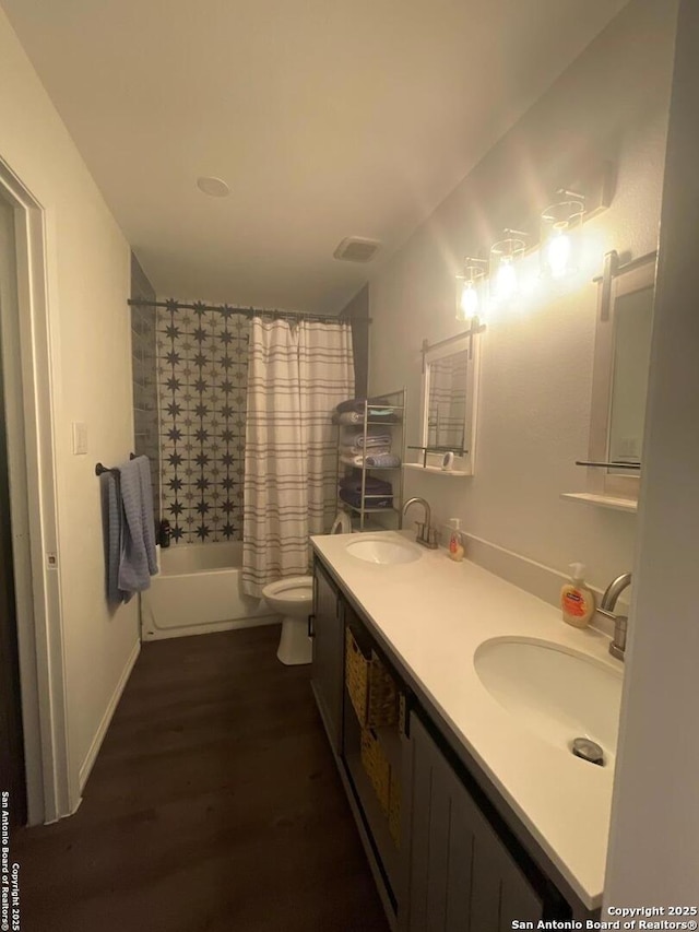 full bath featuring double vanity, toilet, shower / tub combo with curtain, and a sink