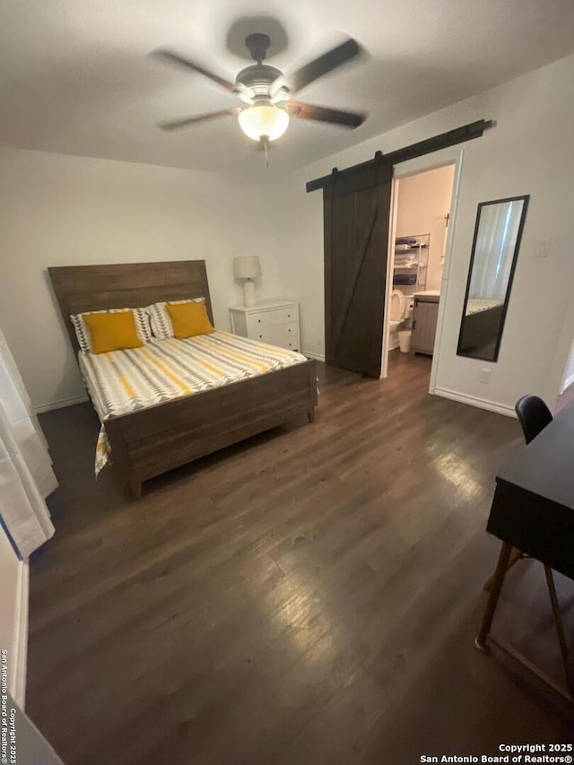 bedroom featuring a barn door, baseboards, a ceiling fan, and dark wood-style flooring