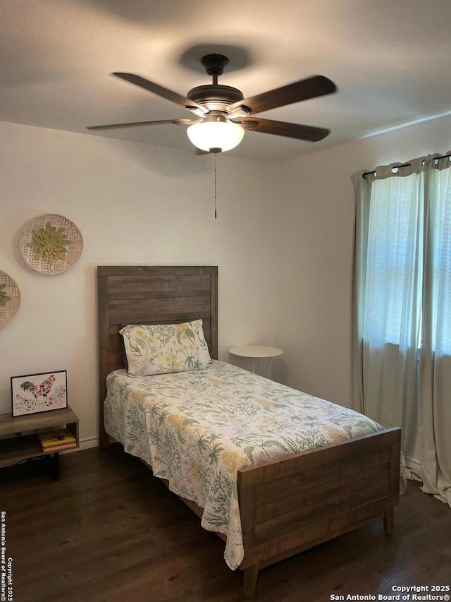 bedroom featuring a ceiling fan and wood finished floors