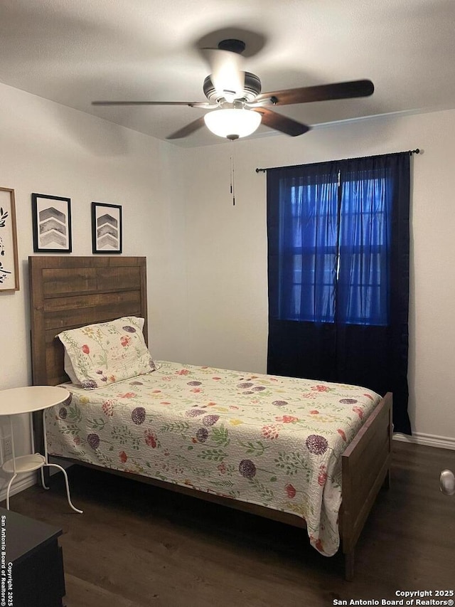 bedroom with a ceiling fan and wood finished floors