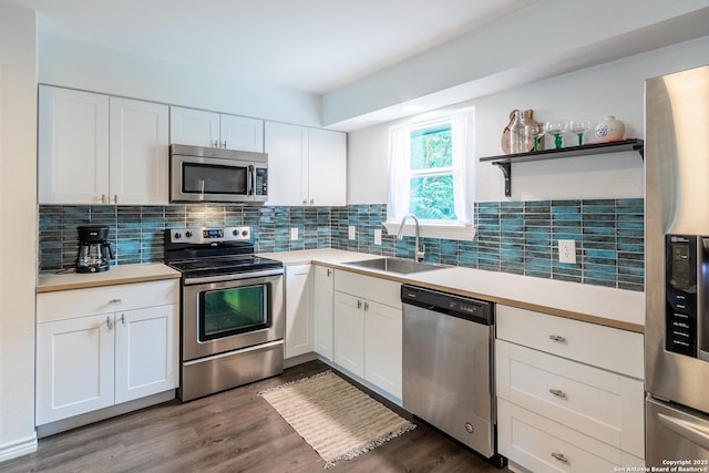 kitchen featuring decorative backsplash, appliances with stainless steel finishes, light countertops, and a sink