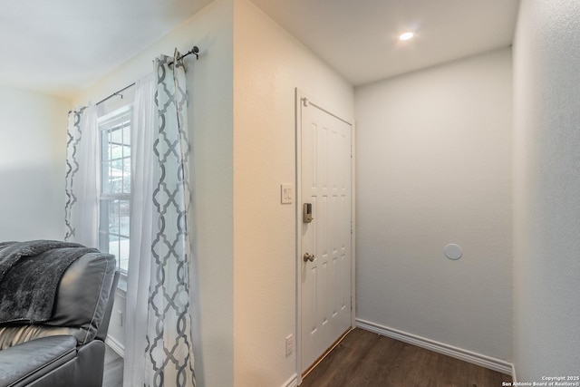 entrance foyer featuring baseboards and dark wood finished floors