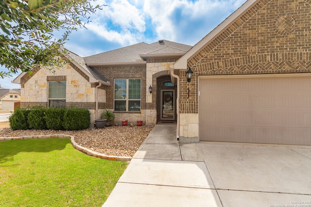 french provincial home featuring driveway, stone siding, a shingled roof, a garage, and brick siding