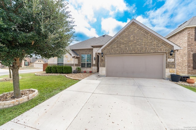 view of front facade featuring brick siding, a garage, concrete driveway, and a front lawn