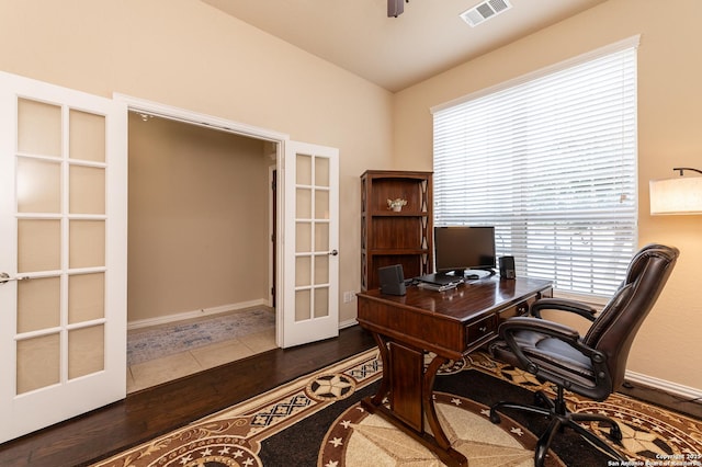 office with wood finished floors, visible vents, baseboards, ceiling fan, and french doors