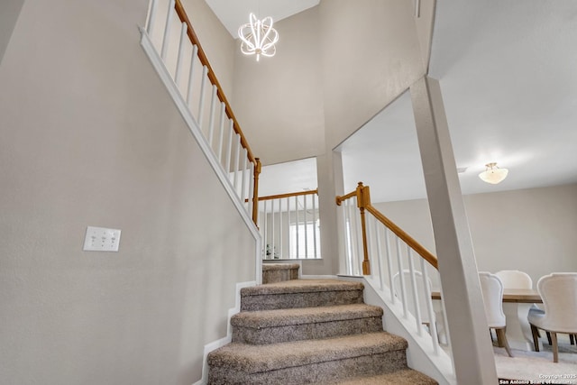 stairs with a high ceiling and a notable chandelier