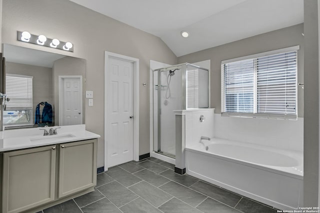 full bath with a garden tub, a shower stall, tile patterned flooring, lofted ceiling, and vanity