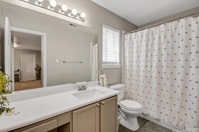 bathroom featuring vanity, a shower with curtain, visible vents, tile patterned floors, and toilet