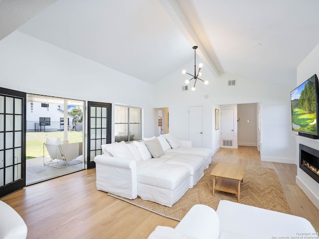 living room with a notable chandelier, visible vents, beamed ceiling, and light wood-type flooring