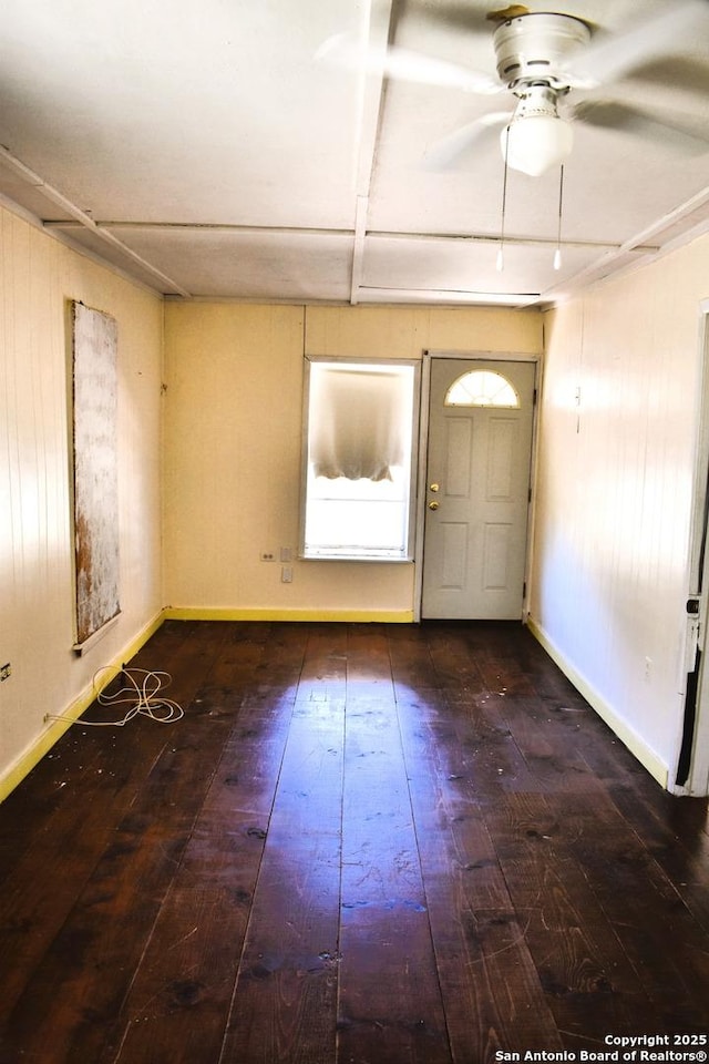 foyer entrance featuring baseboards, a ceiling fan, and hardwood / wood-style flooring