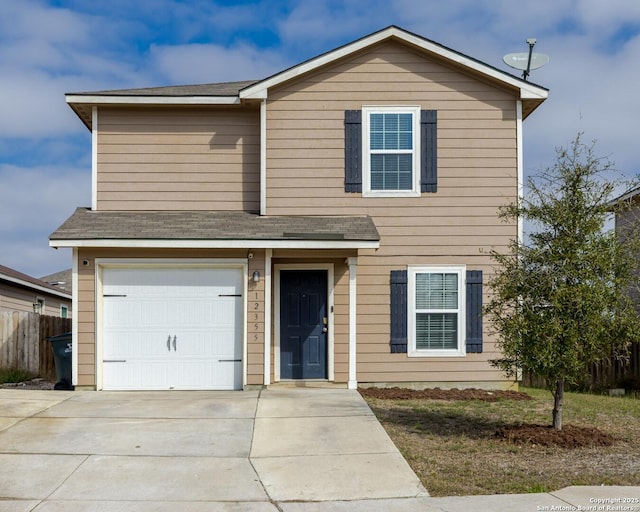 traditional-style home featuring concrete driveway, fence, a garage, and a shingled roof