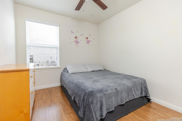 bedroom with baseboards, ceiling fan, and light wood finished floors