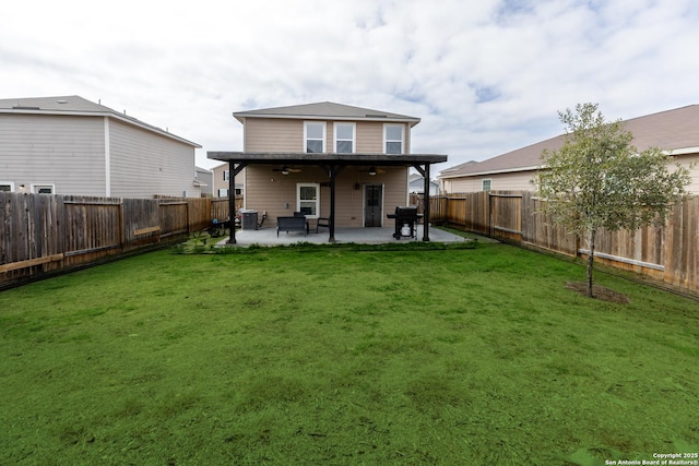 rear view of property featuring a patio, a yard, a ceiling fan, and a fenced backyard