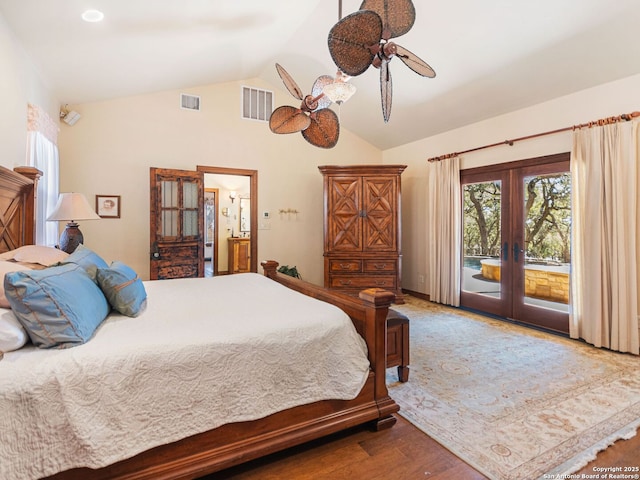 bedroom featuring visible vents, lofted ceiling, french doors, wood finished floors, and access to outside