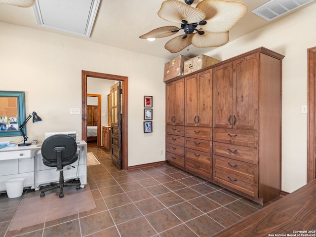 office area with dark tile patterned floors, a ceiling fan, and visible vents