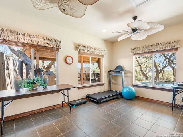 exercise area featuring tile patterned floors, recessed lighting, a ceiling fan, and baseboards